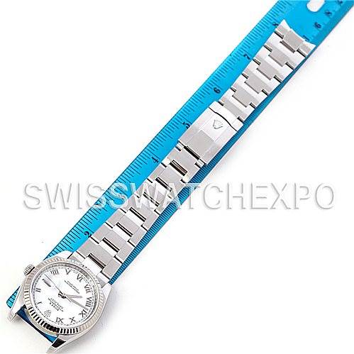 This image shows an overhead view of a Rolex Datejust 116234 Men's Stainless Steel White Dial 116234 Men's Stainless Steel White Dial watch, displaying its face, bracelet, and clasp alongside a blue ruler for scale.