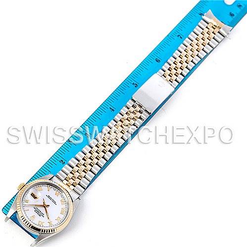 This image shows a full view of the Rolex Datejust 16233 Men's Steel and Gold (two tone) Mother of Pearl Dial 16233 Men's Steel and Gold (two tone) Mother of Pearl Dial model watch, including the face, bezel, and bracelet, alongside a blue ruler for scale.