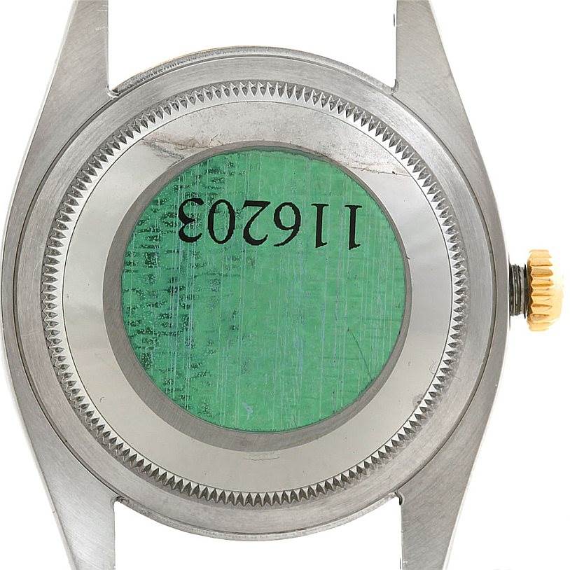 The image shows the back casing of a Rolex Datejust 116203 Men's Stainless Steel Grey Dial 116203 Men's Stainless Steel Grey Dial watch, highlighting the serial number and crown.