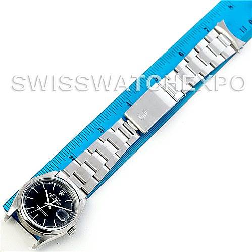 This image shows a top-down view of a Rolex Datejust 16200 Men's Stainless Steel Black Dial 16200 Men's Stainless Steel Black Dial watch, its stainless steel bracelet extended and aligned with a ruler.