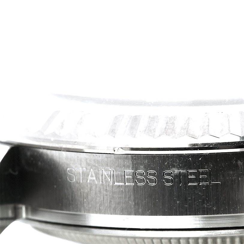 This image shows a close-up of the side of the case of a Rolex Datejust 116234 Men
s Stainless Steel Silver Dial 116234 Men
s Stainless Steel Silver Dial watch, highlighting the stainless steel inscription.