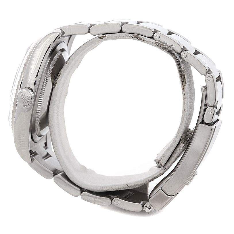 This side view of the Rolex Datejust 116234 Men
s Stainless Steel Silver Dial 116234 Men
s Stainless Steel Silver Dial watch shows the case, crown, and part of the bracelet.