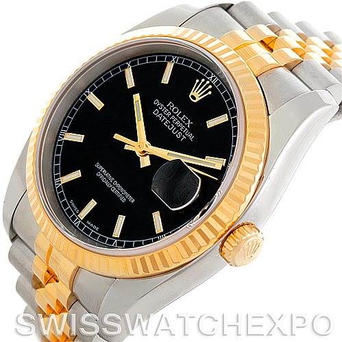 This image shows a close-up of a Rolex Datejust 116233 Men
s Stainless Steel Black Dial 116233 Men
s Stainless Steel Black Dial watch, highlighting the black dial, gold fluted bezel, and part of the two-tone bracelet.