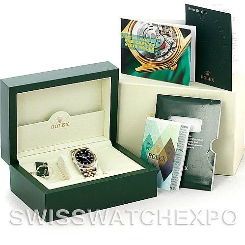 The image shows a Rolex Datejust 116233 Men
s Stainless Steel Black Dial 116233 Men
s Stainless Steel Black Dial watch in its box at an angle that displays the dial, along with documents and accessories.