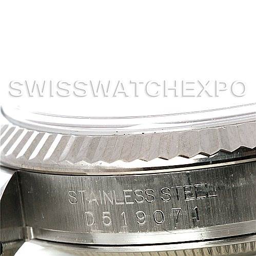 This image shows a close-up of the side case and fluted bezel of a Rolex Datejust 116234 Men's Stainless Steel Silver Dial 116234 Men's Stainless Steel Silver Dial watch, highlighting the serial number engraving.
