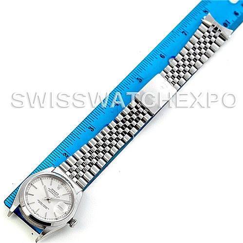 The image shows a top-down view of a Rolex Datejust 16200 Men's Stainless Steel Silver Dial 16200 Men's Stainless Steel Silver Dial model, including its face and metal bracelet next to a blue ruler.