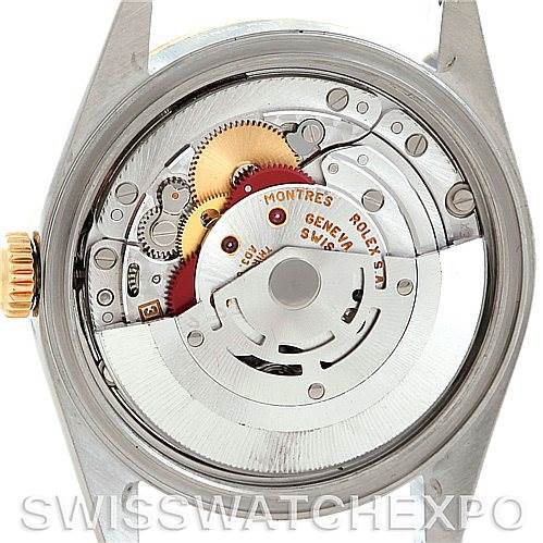 The image shows the Rolex Datejust 16203 Men
s Steel and Gold (two tone) Champagne Dial 16203 Men
s Steel and Gold (two tone) Champagne Dial model from the back, revealing its internal mechanical movement and gears.
