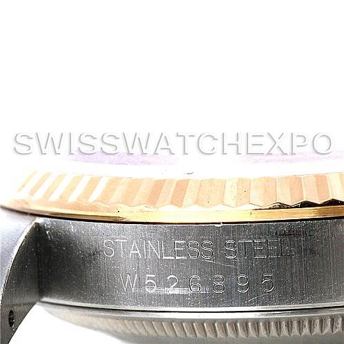 This image shows a close-up of the side of a Rolex Datejust 16233 Men's Steel and Gold (two tone) White Dial 16233 Men's Steel and Gold (two tone) White Dial watch case, focusing on the serial number and part of the bezel.