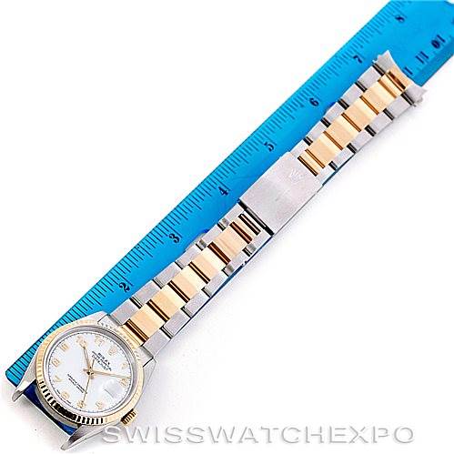 The image shows a top-down view of a Rolex Datejust 16233 Men's Steel and Gold (two tone) White Dial 16233 Men's Steel and Gold (two tone) White Dial watch with its bracelet laid out next to a blue ruler.