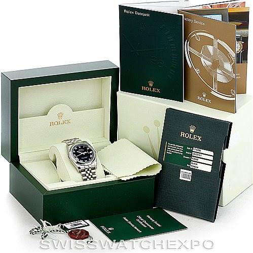 The image displays a Rolex Datejust 116200 Men
s Stainless Steel Black Dial 116200 Men
s Stainless Steel Black Dial watch set at an angle within its open box, surrounded by brand documents and tags.
