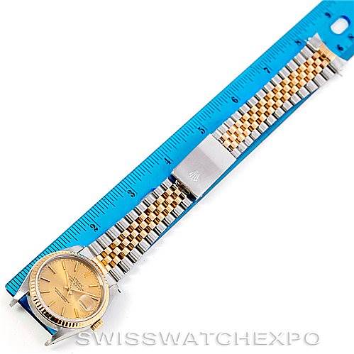 This image shows a Rolex Datejust 16233 Men's Steel and Gold (two tone) Champagne Dial 16233 Men's Steel and Gold (two tone) Champagne Dial watch laid flat, featuring the dial, bezel, and full bracelet next to a blue measuring ruler.