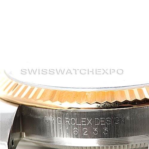 This close-up image of a Rolex Datejust 116233 Men's Stainless Steel White Dial 116233 Men's Stainless Steel White Dial watch shows part of the fluted bezel and the side engraving.
