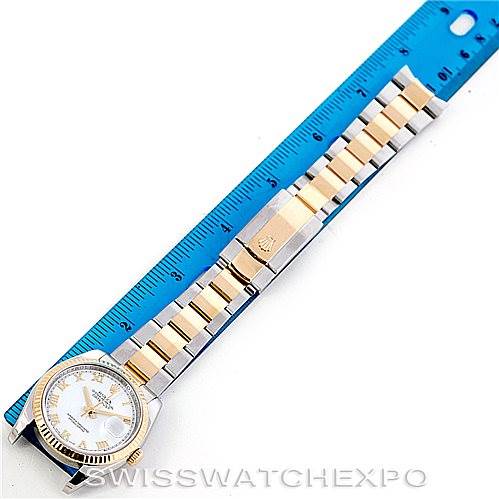 The image shows a Rolex Datejust 116233 Men's Stainless Steel White Dial 116233 Men's Stainless Steel White Dial watch laid flat next to a blue ruler, displaying its dial, case, and bracelet.
