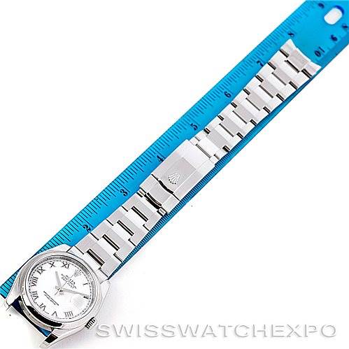 This image shows a Rolex Datejust 116200 Men
s Stainless Steel White Dial 116200 Men
s Stainless Steel White Dial watch laid flat with a blue ruler for size reference.