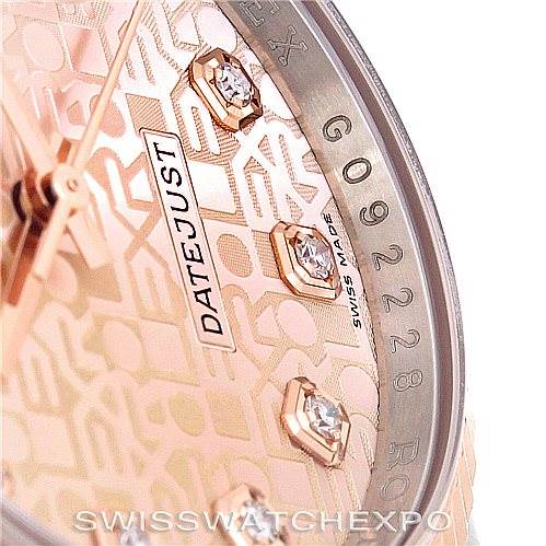 This close-up shot of a Rolex Datejust 116231 Men's Steel and Gold (two tone) Pink Dial 116231 Men's Steel and Gold (two tone) Pink Dial watch shows part of the dial, diamond hour markers, and the date window.
