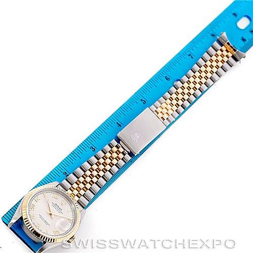 The image shows the full length of a Rolex Datejust 16233 Men's Steel and Gold (two tone) Beige Dial 16233 Men's Steel and Gold (two tone) Beige Dial watch laid flat next to a blue ruler.