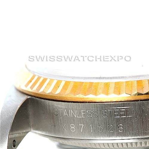 The image shows a close-up side view of a Rolex Datejust 16233 Men's Steel and Gold (two tone) Champagne Dial 16233 Men's Steel and Gold (two tone) Champagne Dial model, featuring the bezel and part of the case with engraved serial number.