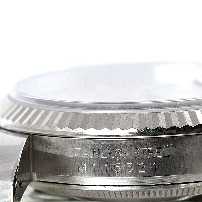 This image shows a side view of the Rolex Datejust 116234 Men's Stainless Steel Silver Dial 116234 Men's Stainless Steel Silver Dial watch, highlighting the bezel, serial number, and "Stainless Steel" engraving.