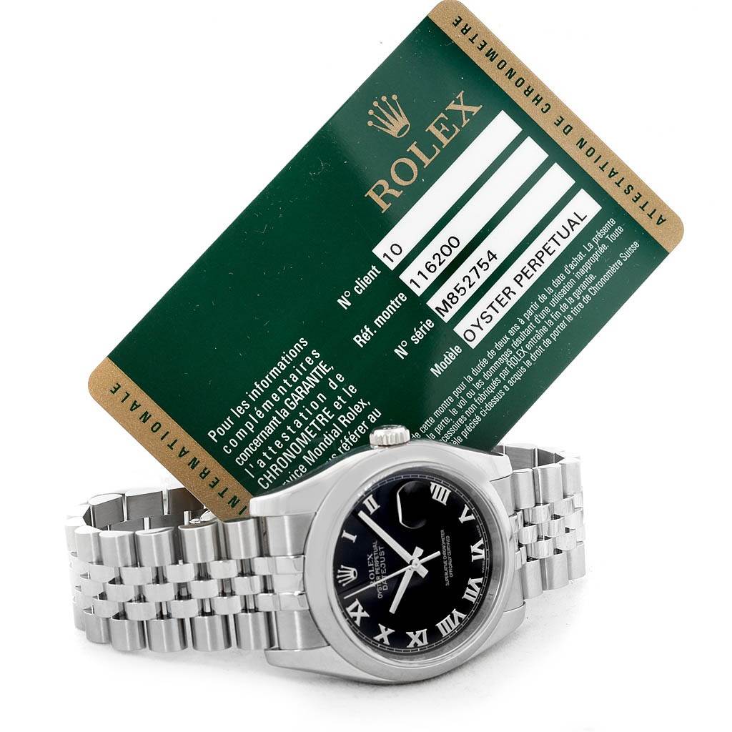 The image shows a Rolex Datejust 116200-BKRJ Men's Stainless Steel Black Dial 116200-BKRJ Men's Stainless Steel Black Dial watch placed face-up with an accompanying warranty card angled behind it.