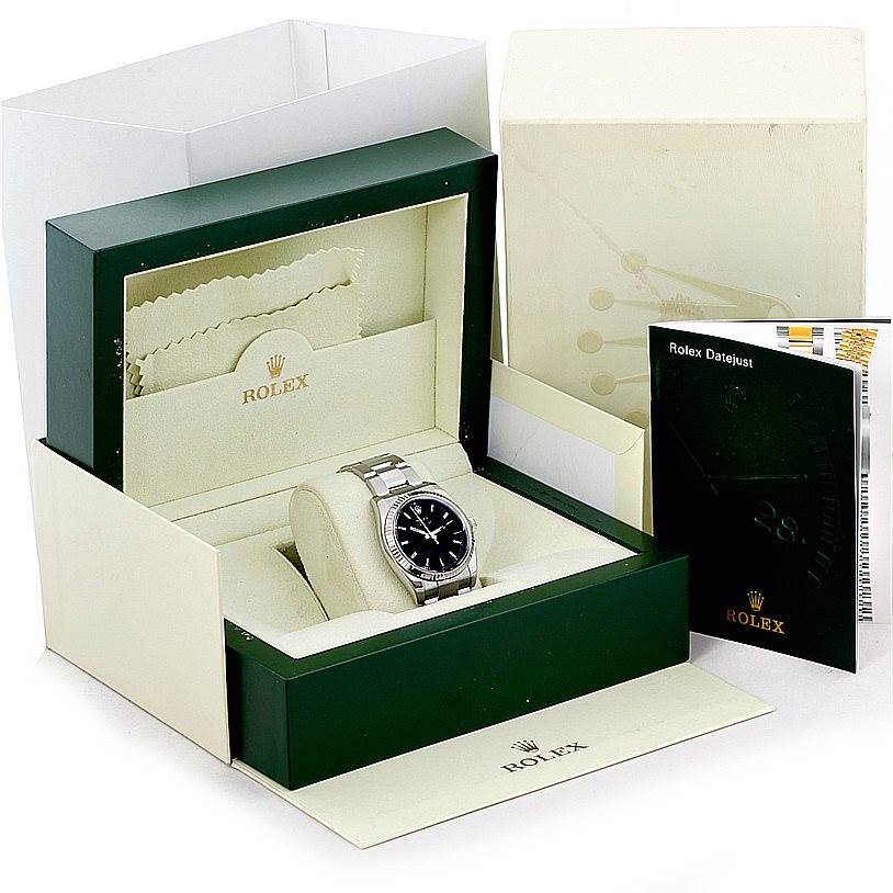 The Rolex Datejust 116234 Men
s Stainless Steel Black Dial 116234 Men
s Stainless Steel Black Dial watch is shown inside its box with a booklet on the side.