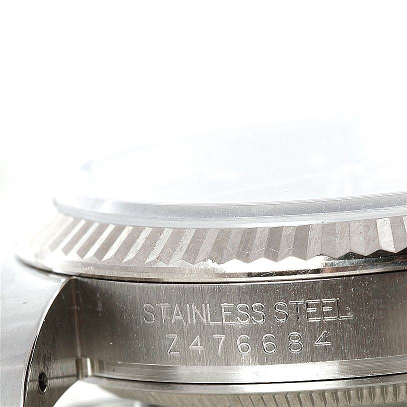 The image shows a close-up of the case side and bezel edge of a Rolex Datejust 116234 Men
s Stainless Steel Black Dial 116234 Men
s Stainless Steel Black Dial watch, highlighting the serial number.