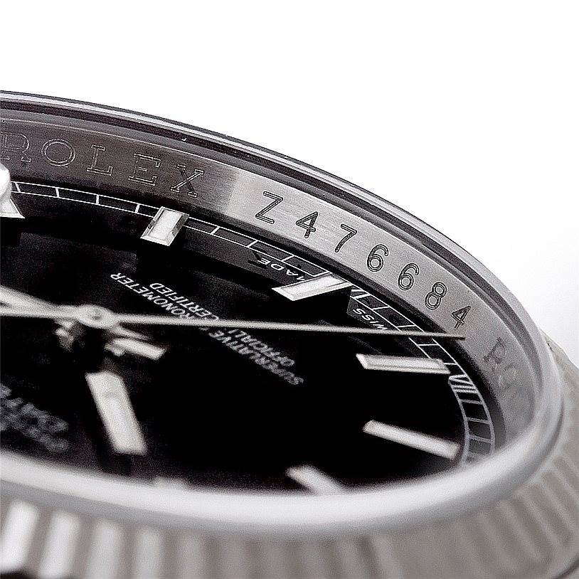 This macro shot of the Rolex Datejust 116234 Men
s Stainless Steel Black Dial 116234 Men
s Stainless Steel Black Dial watch shows the dial, bezel, and the serial number inside the case.