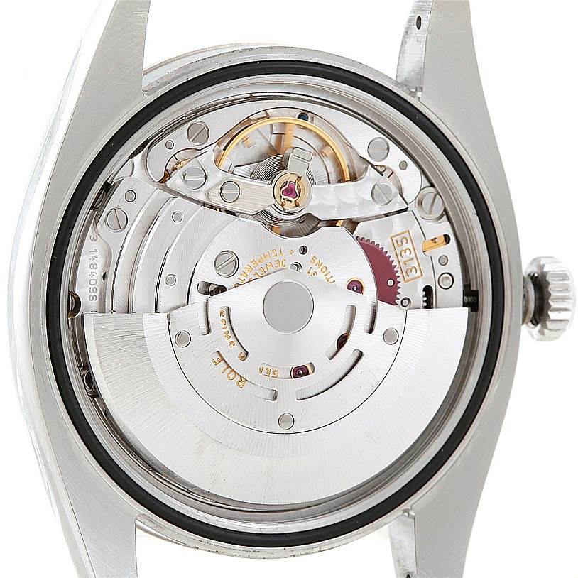 The image shows the internal movement mechanism of a Rolex Datejust 116234 Men
s Stainless Steel Black Dial 116234 Men
s Stainless Steel Black Dial watch from the back angle, highlighting its intricate parts.