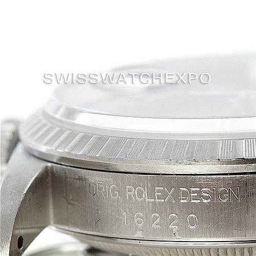 The image shows a close-up of the bezel and case side of a Rolex Datejust 16220 Men's Stainless Steel Blue Dial 16220 Men's Stainless Steel Blue Dial 16220 with engraving visible.