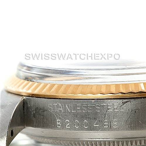 This close-up image shows the side view of a Rolex Datejust 16013 Men's Stainless Steel White Dial 16013 Men's Stainless Steel White Dial watch, focusing on the bezel, crystal, and case with serial engraving.