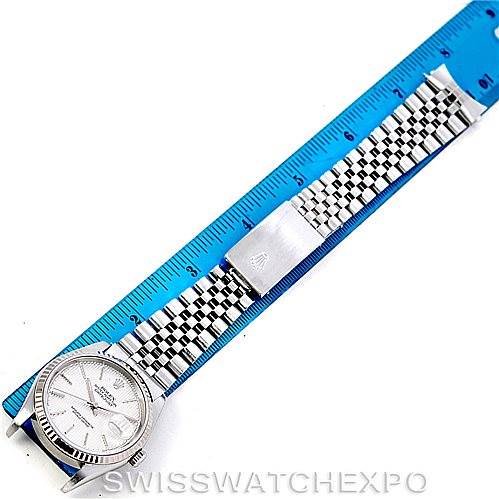 The image shows a top-down view of a Rolex Datejust 16234 Men's Stainless Steel Silver Dial 16234 Men's Stainless Steel Silver Dial model watch next to a ruler, displaying its watch face and metal bracelet.