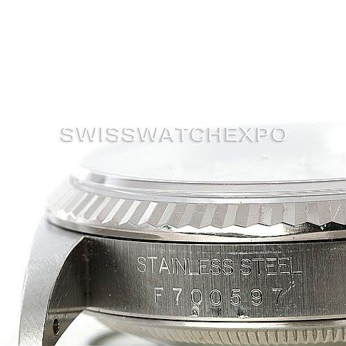 The image shows a close-up of the side of a Rolex Datejust 16234 Men's Stainless Steel Silver Dial 16234 Men's Stainless Steel Silver Dial watch, highlighting its stainless steel case and serial number.