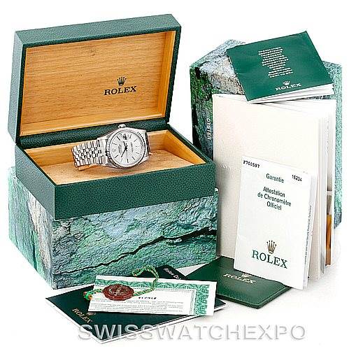 The image shows a Rolex Datejust 16234 Men's Stainless Steel Silver Dial 16234 Men's Stainless Steel Silver Dial watch, its open green box, booklets, warranty cards, and a tag.