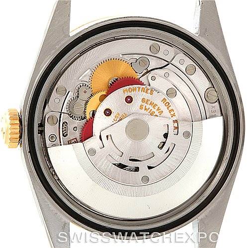 The image shows the internal mechanics and movement of a Rolex Datejust 16233 Men
s Steel and Gold (two tone) Beige Dial 16233 Men
s Steel and Gold (two tone) Beige Dial watch, viewed from the back with the case opened.