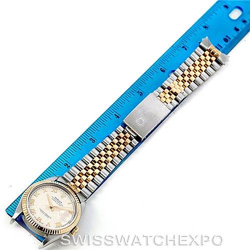 The image shows a Rolex Datejust 16233 Men
s Steel and Gold (two tone) Beige Dial 16233 Men
s Steel and Gold (two tone) Beige Dial watch laid flat next to a blue ruler, showcasing the watch face, bracelet, and clasp.