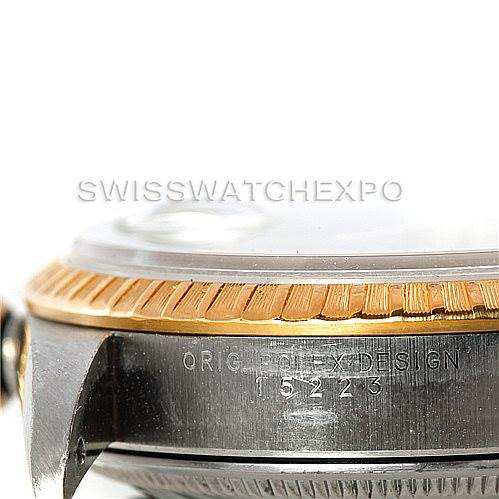 The image shows a close-up side view of the Rolex Datejust 15223 Men's Steel and Gold (two tone) Black Dial 15223 Men's Steel and Gold (two tone) Black Dial's case, highlighting the fluted bezel and engraving with the model number.