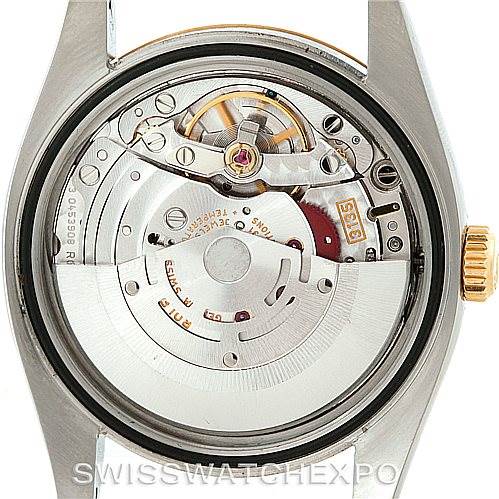 The image shows a rear view of the Rolex Datejust 116233 Men's Stainless Steel Blue Dial 116233 Men's Stainless Steel Blue Dial, highlighting its internal movement and mechanical parts.