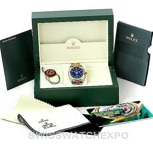 The image shows a Rolex Datejust 116233 Men's Stainless Steel Blue Dial 116233 Men's Stainless Steel Blue Dial watch in its open box with accessories, including booklets, a cleaning cloth, and a hang tag.