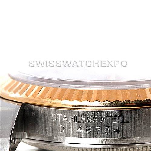 This image shows a close-up of the stainless steel case and fluted bezel of a Rolex Datejust 116233 Men's Stainless Steel White Dial 116233 Men's Stainless Steel White Dial watch, displaying the serial number.
