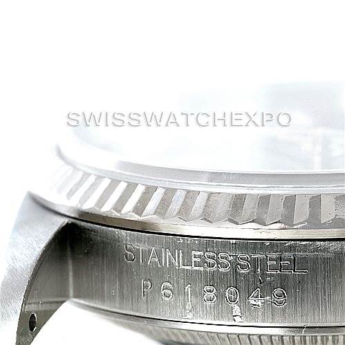 The image shows a close-up side view of the Rolex Datejust 16234 Men's Stainless Steel Black Dial 16234 Men's Stainless Steel Black Dial model, highlighting the engraved stainless steel case and bezel.
