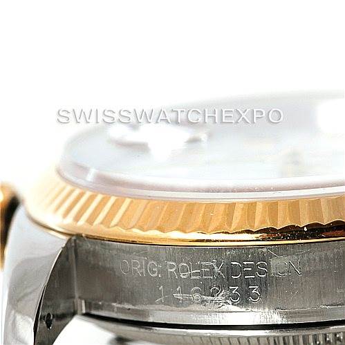 This close-up shows the side view of the Rolex Datejust 116233 Men
s Stainless Steel White Dial 116233 Men
s Stainless Steel White Dial watch, highlighting its fluted bezel and the engraved serial number on the case.