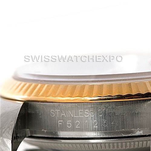 This image shows a close-up angle of a Rolex Datejust 116233 Men
s Stainless Steel White Dial 116233 Men
s Stainless Steel White Dial
s case, focusing on its fluted bezel and the engraved serial number.