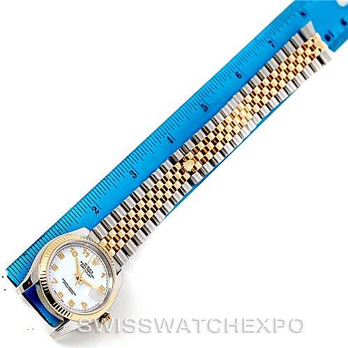 The image shows a top-down view of a Rolex Datejust 116233 Men
s Stainless Steel White Dial 116233 Men
s Stainless Steel White Dial model watch, displaying the face and full bracelet next to a blue ruler.