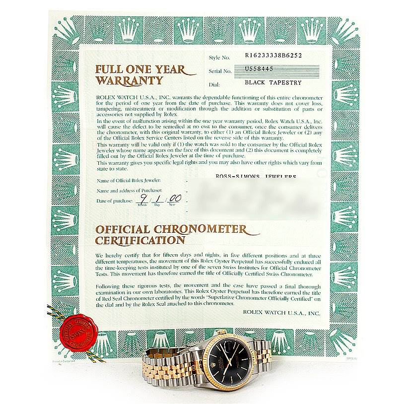 The image shows the Rolex Datejust 16233 Men's Steel and Gold (two tone) Black Dial 16233 Men's Steel and Gold (two tone) Black Dial watch laid flat, angled slightly to the left, with its warranty and chronometer certification papers.