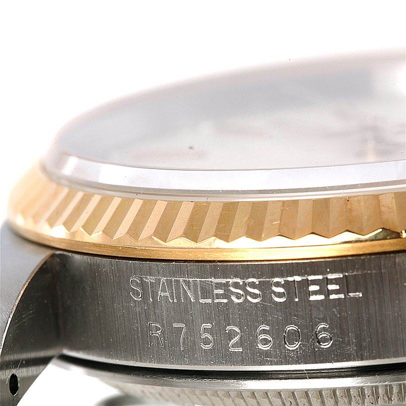 This image shows a close-up angle of the bezel and case side of a Rolex Datejust 16233 Men's Steel and Gold (two tone) Beige Dial 16233 Men's Steel and Gold (two tone) Beige Dial watch, highlighting the stainless steel material and a partial serial number.