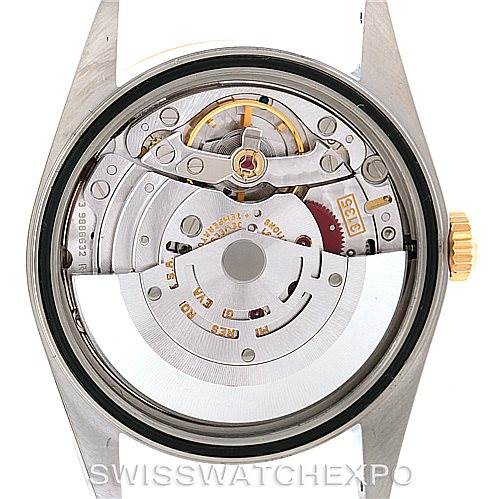 This image shows the internal mechanical movement of a Rolex Datejust 16233 Men's Steel and Gold (two tone) Champagne Dial 16233 Men's Steel and Gold (two tone) Champagne Dial watch from a rear view, highlighting gears and the rotor.