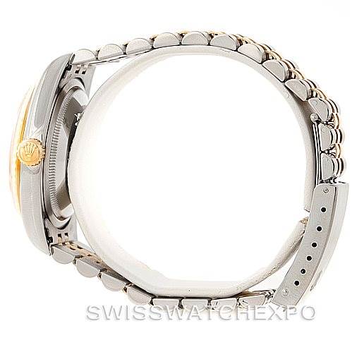 This side view of the Rolex Datejust 16233 Men's Steel and Gold (two tone) Champagne Dial 16233 Men's Steel and Gold (two tone) Champagne Dial watch shows the bracelet, clasp, and partially the crown.