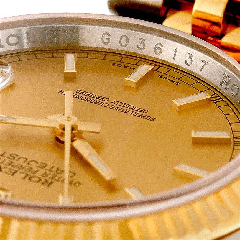 The image shows a close-up of the dial and part of the bezel, showcasing the gold details of the Rolex Datejust 116233 Men
s Stainless Steel Champagne Dial 116233 Men
s Stainless Steel Champagne Dial watch.