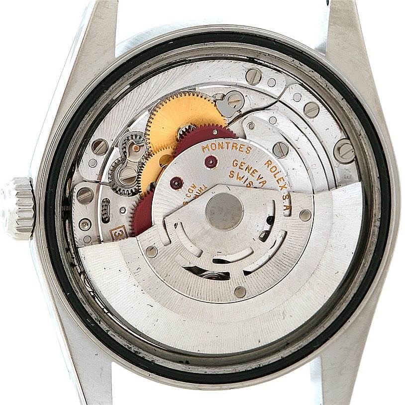 The image shows the internal mechanisms of a Rolex Datejust 16220 Men's Stainless Steel White Dial 16220 Men's Stainless Steel White Dial watch from the back, focusing on gears and the rotor.