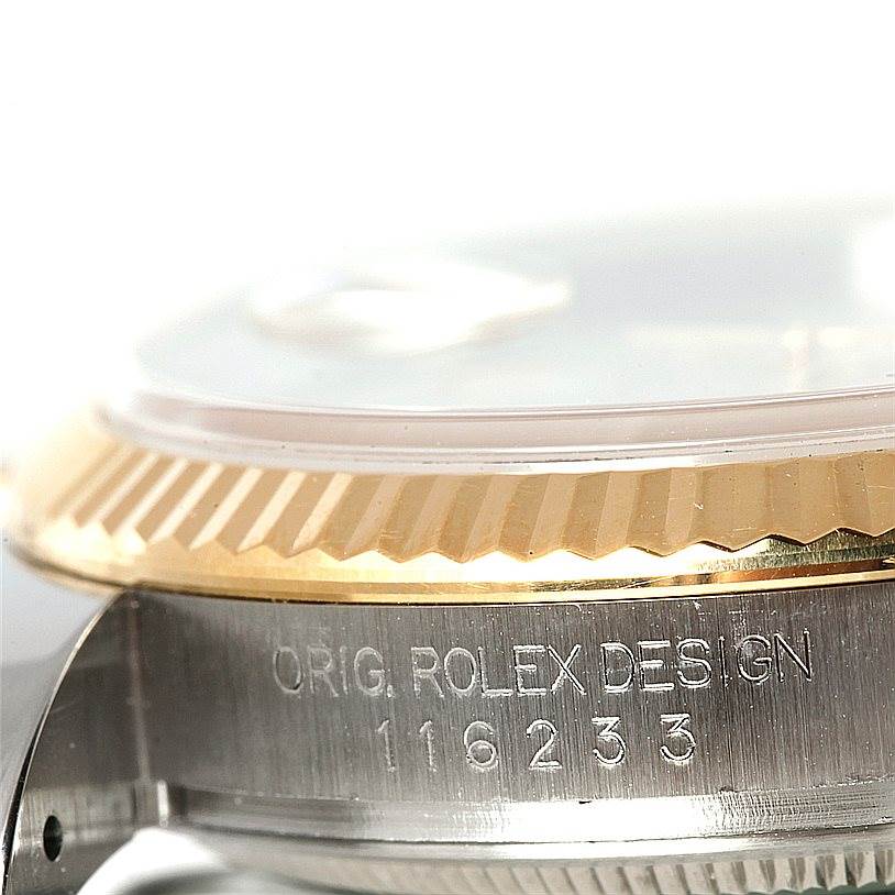 The image shows a close-up side angle of the Rolex Datejust 116233 Men's Stainless Steel Beige Dial 116233 Men's Stainless Steel Beige Dial model, focusing on the fluted bezel and case with engraved serial number.