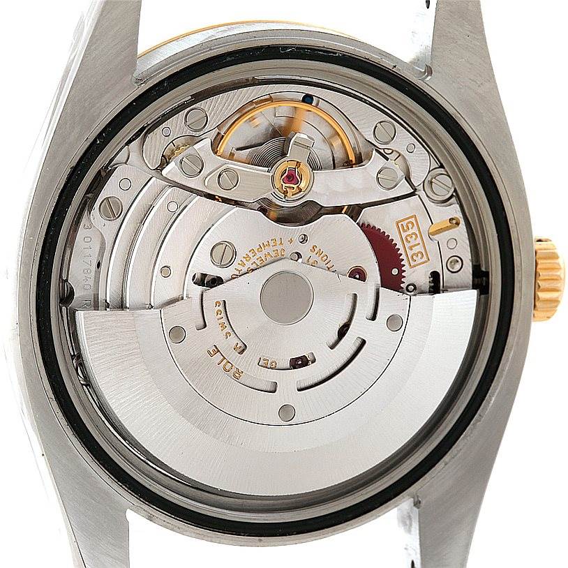 This image shows the movement of a Rolex Datejust 116233 Men's Stainless Steel Beige Dial 116233 Men's Stainless Steel Beige Dial watch viewed from the back, highlighting its intricate mechanical parts.
